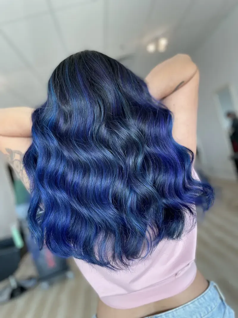 Deep blue dimensional colour melt on long wavy hair